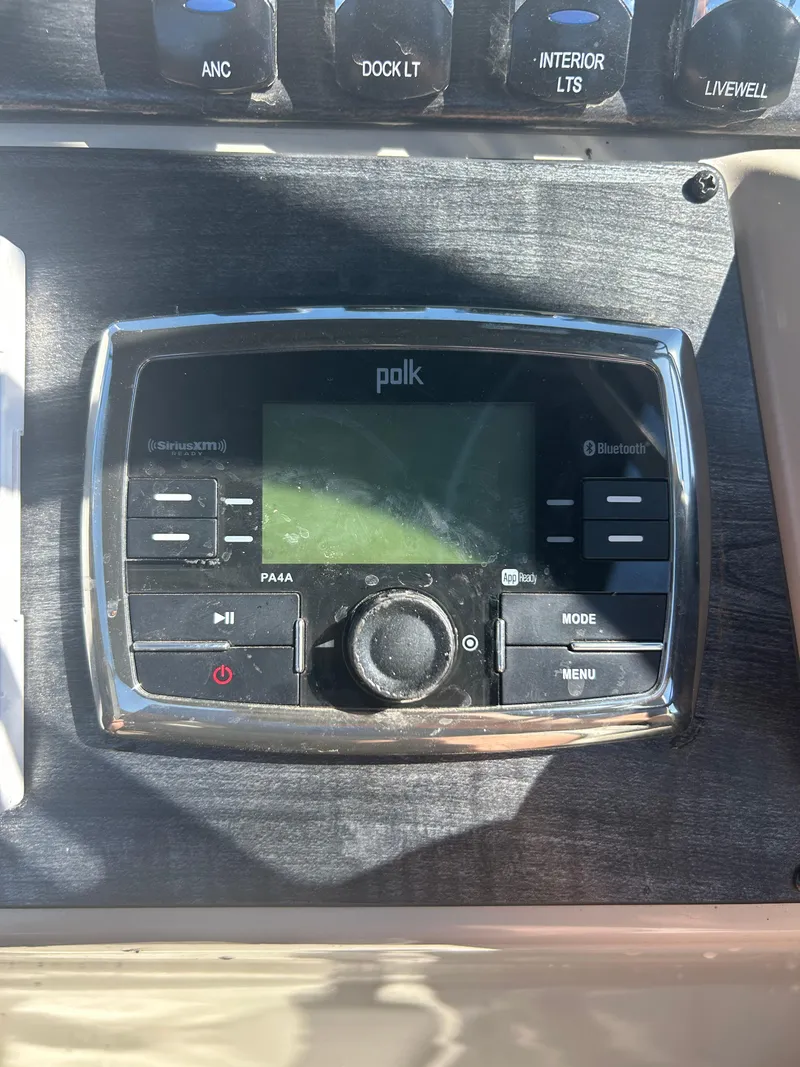 Slide: The Image of Polk audio system on 2019 Harris Sunliner 240 boat dashboard. - 23