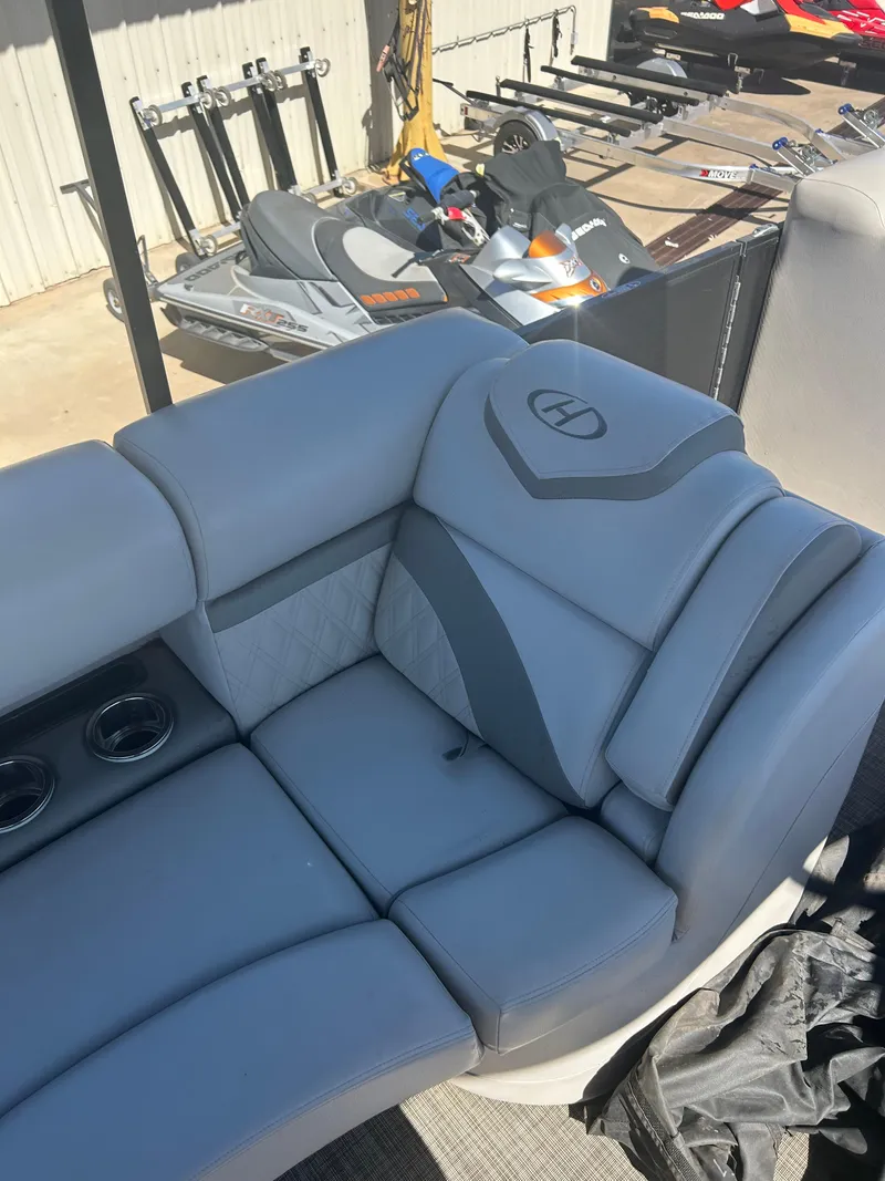 Slide: The Image of 2019 Harris Sunliner 240 boat interior with gray seating and cup holders. - 26