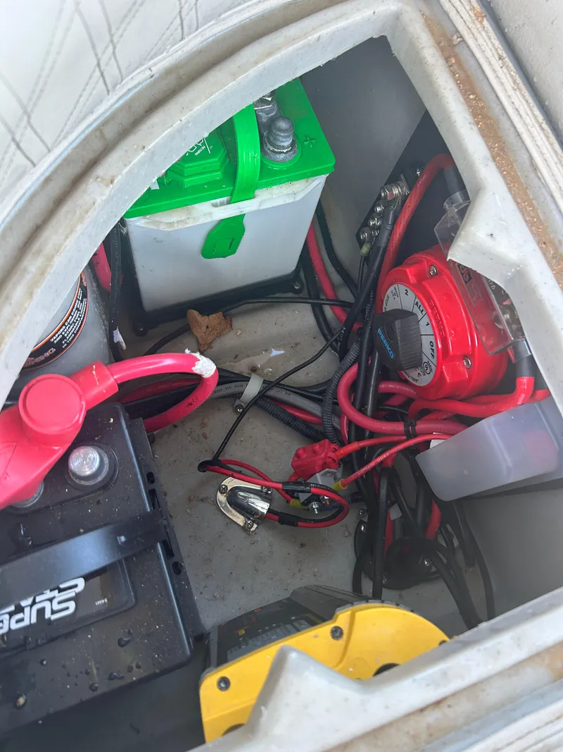 Slide: The Image of 2019 Harris Sunliner 240 boat battery compartment with wiring and components. - 27