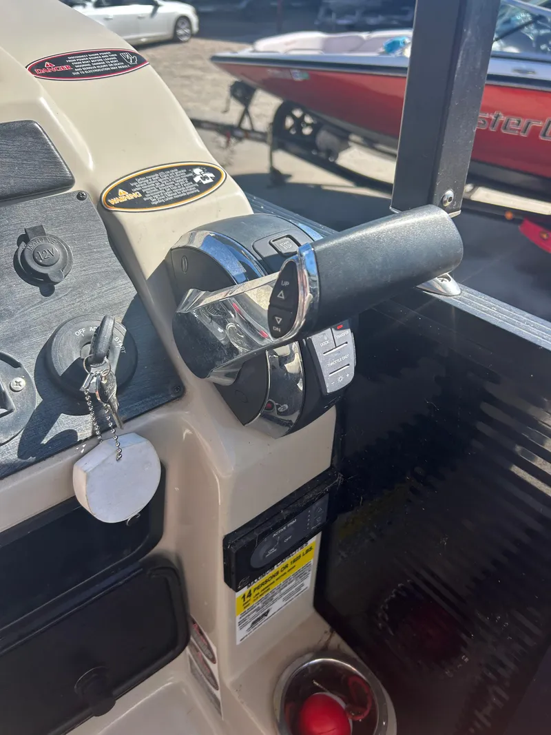 Slide: The Image of Close-up of 2019 Harris Sunliner 240 boat controls and throttle handle. - 28
