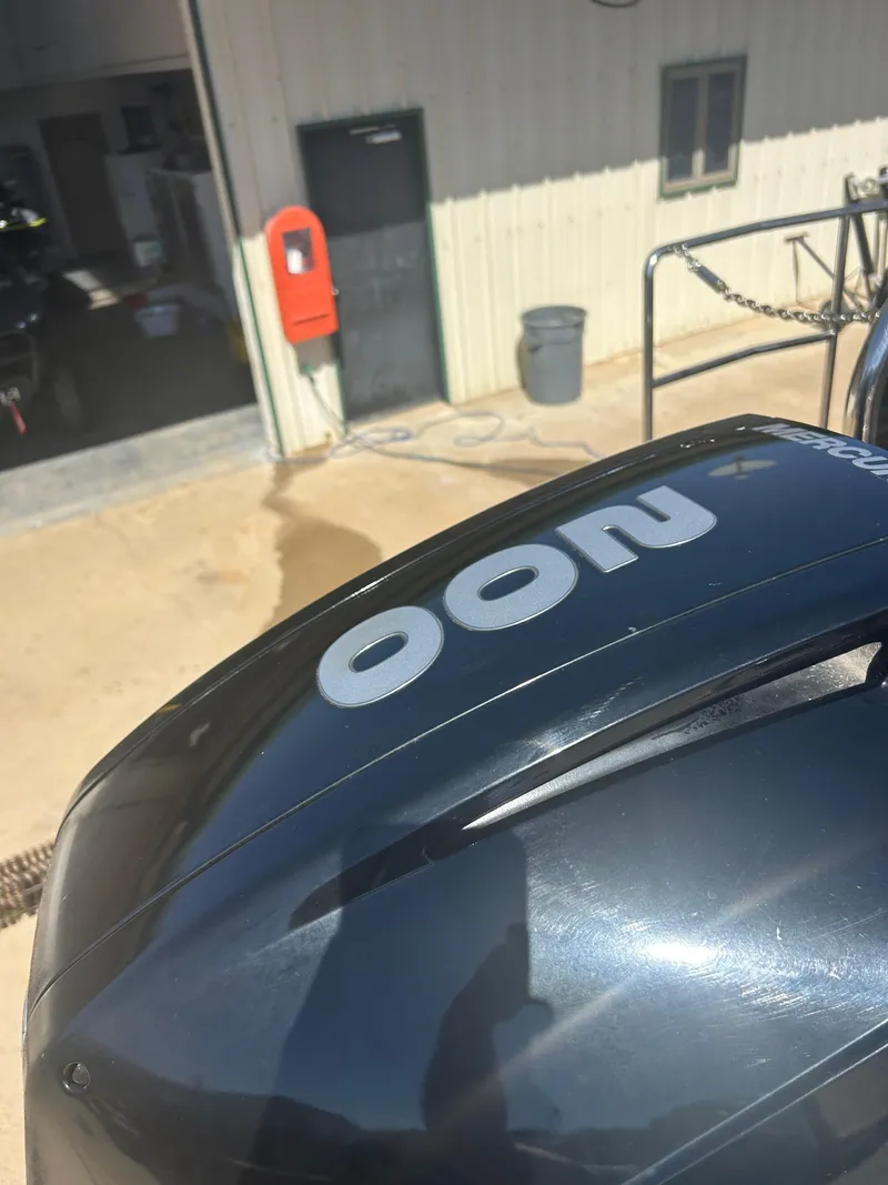 Slide: The Image of 2019 Harris Sunliner 240 boat engine close-up, outdoor setting with building in background. - 36