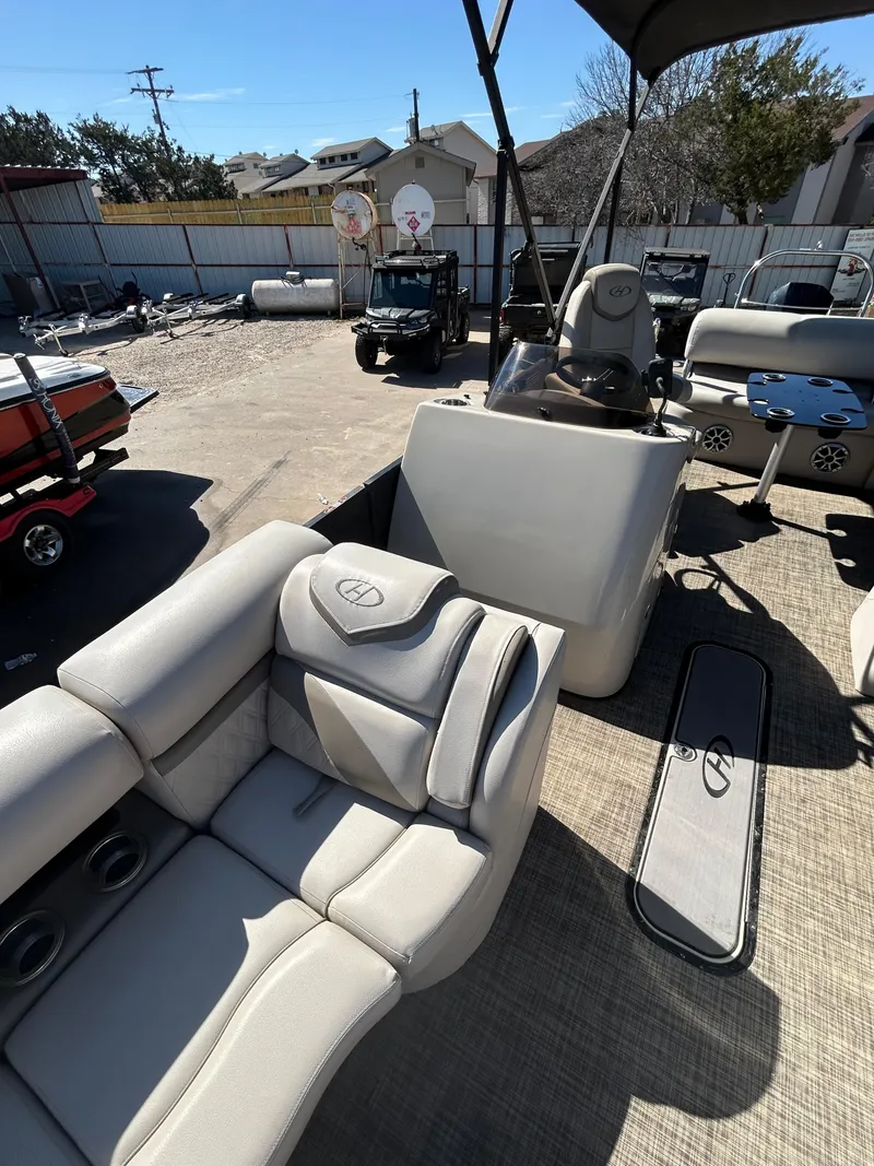 Slide: The Image of 2019 Harris Sunliner 240 pontoon boat with plush seating and modern design. - 4