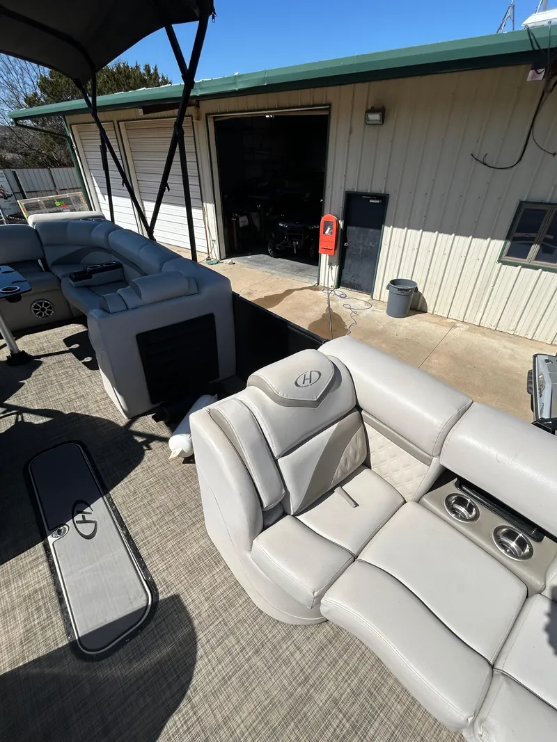 Slide: The Image of 2019 Harris Sunliner 240 pontoon boat with spacious seating and modern design. - 7