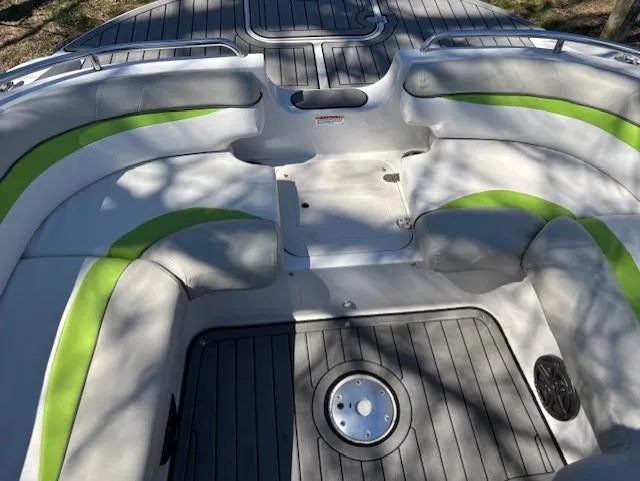 Slide: The Image of 2021 Starcraft MDX 211 E O/B boat interior with gray and green seating. - 10