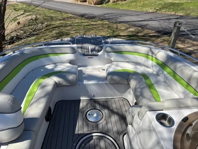 Slide: The Image of 2021 Starcraft MDX 211 E O/B boat interior with green-accented seating and gray flooring. - 11