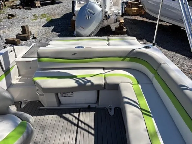 Slide: The Image of 2021 Starcraft MDX 211 E O/B boat interior with green-accented seating and outboard motor. - 19