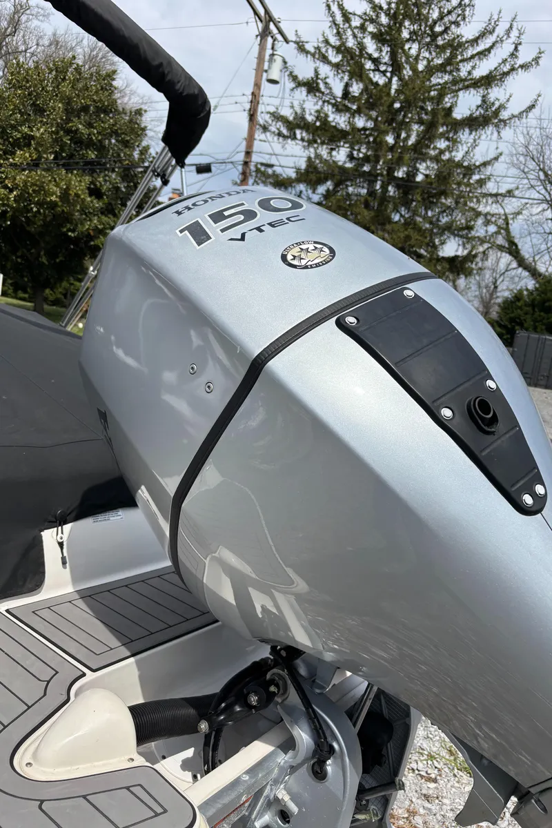 Slide: The Image of 2021 Starcraft MDX 211 E O/B boat engine, 150 HP, silver finish. - 21