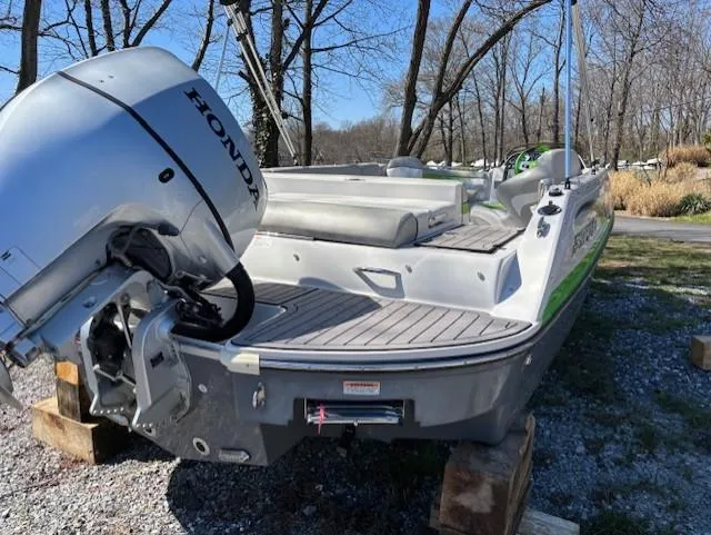 Slide: The Image of 2021 Starcraft MDX 211 E O/B boat with Honda outboard motor, parked on wooden blocks. - 3