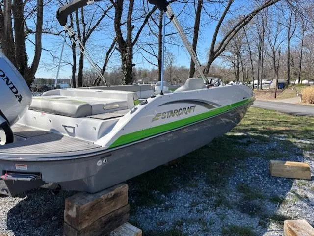 Slide: The Image of 2021 Starcraft MDX 211 E O/B boat on wooden blocks, parked outdoors. - 6