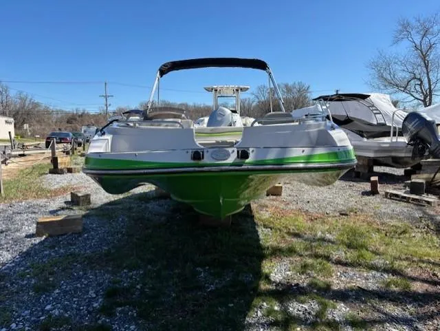 Slide: The Image of 2021 Starcraft MDX 211 E O/B boat, green and white, parked on gravel. - 9