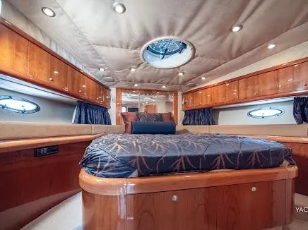 Slide: The Image of Luxurious interior of 2007 Sunseeker Predator 55 yacht with elegant wood finishes and cozy bedding. - 14