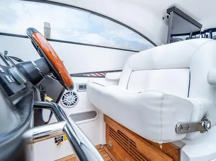 Slide: The Image of Interior of 2007 Sunseeker Predator 55 yacht, featuring white leather seating and wooden accents. - 17