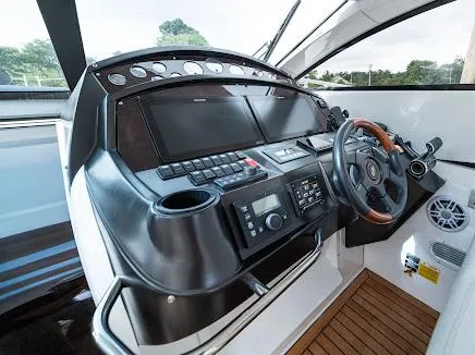 Slide: The Image of Control panel of 2007 Sunseeker Predator 55 yacht with steering wheel and navigation instruments. - 32