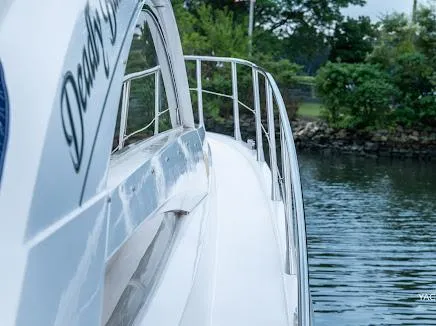 Slide: The Image of 2007 Sunseeker Predator 55 yacht on calm water, side view with lush greenery. - 38