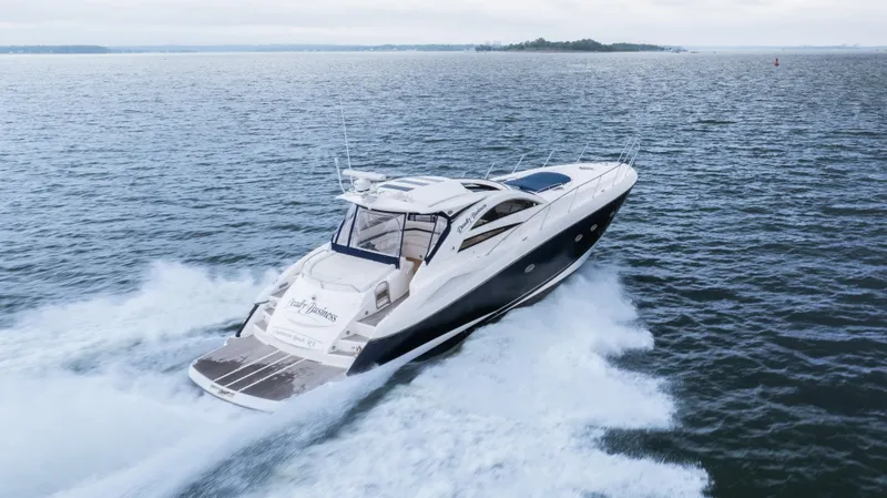 Slide: The Image of 2007 Sunseeker Predator 55 yacht cruising on open water, creating a dynamic wake. - 41