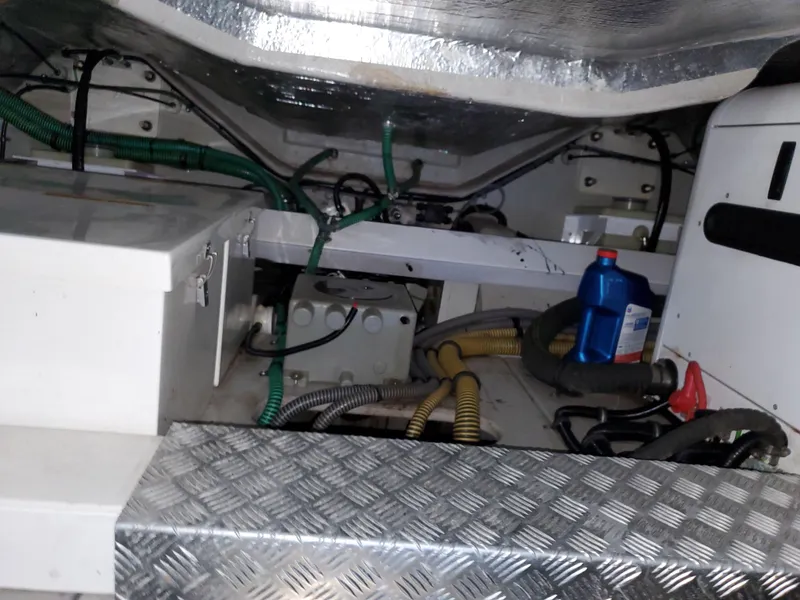 Slide: The Image of Engine compartment of a 2007 Sunseeker Predator 55 yacht, featuring cables and maintenance supplies. - 43