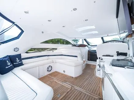 Slide: The Image of Luxurious interior of 2007 Sunseeker Predator 55 yacht with white seating and wooden flooring. - 7