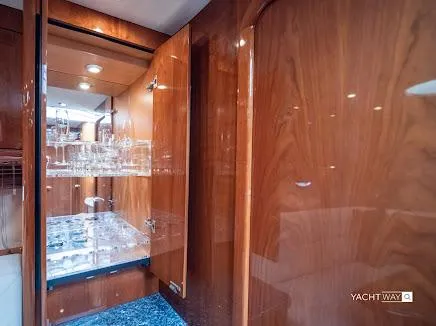 Slide: The Image of 2007 Sunseeker Predator 55 yacht interior with wooden cabinetry and glassware display. - 9