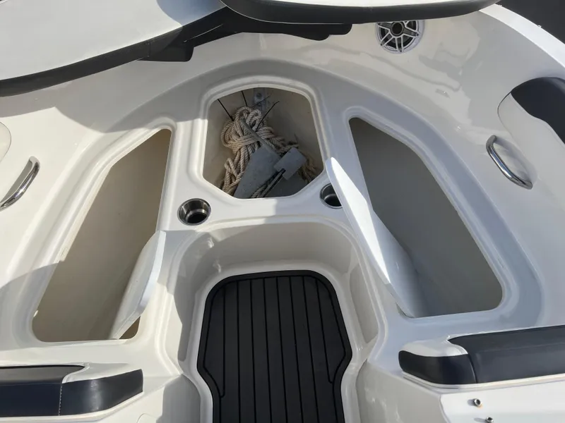 Slide: The Image of 2021 Bayliner VR5 Bowrider I/O boat interior with storage compartments and seating. - 12
