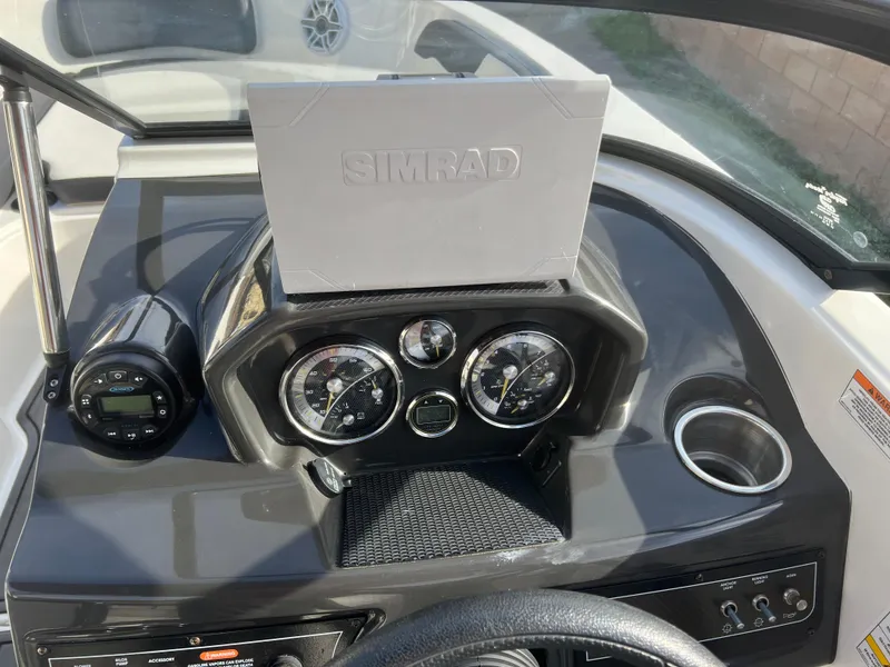 Slide: The Image of 2021 Bayliner VR5 Bowrider I/O dashboard with Simrad display and gauges. - 14