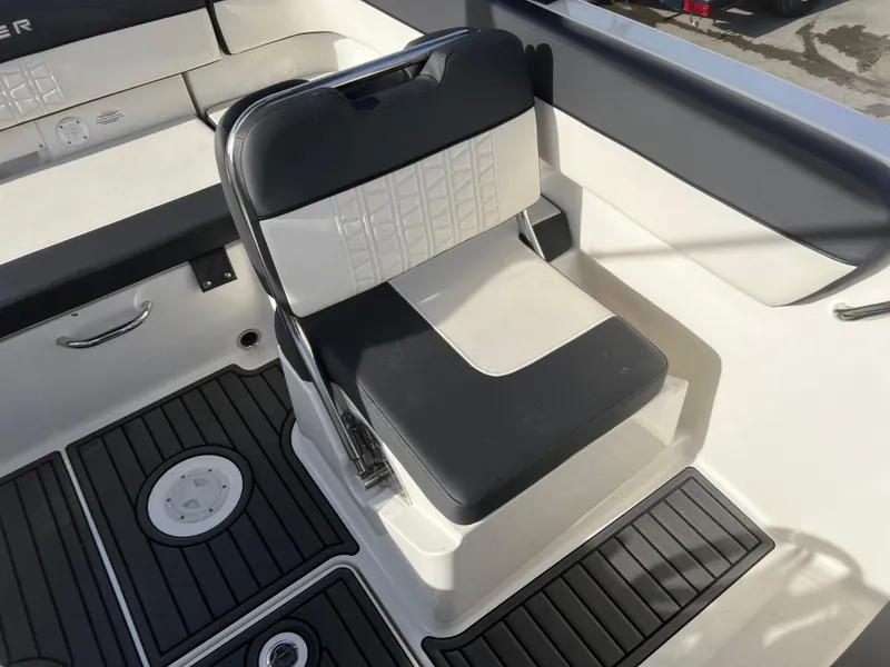 Slide: The Image of 2021 Bayliner VR5 Bowrider I/O interior with black and white seating and deck details. - 19