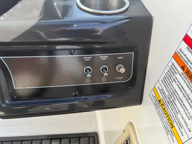 Slide: The Image of Control panel of 2021 Bayliner VR5 Bowrider I/O with switches for anchor light, running light, and horn. - 25