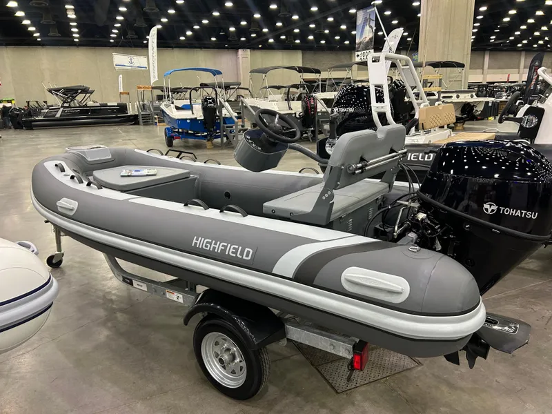 Slide: The Image of 2024 Highfield Classic 380 FCT inflatable boat displayed indoors on a trailer. - 1