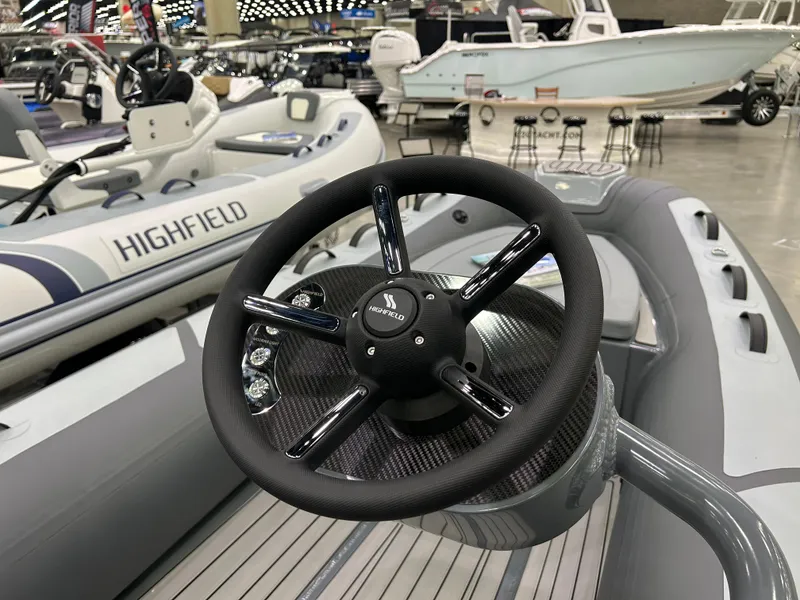 Slide: The Image of 2024 Highfield Classic 380 FCT boat steering wheel, showcased at a boat exhibition. - 4