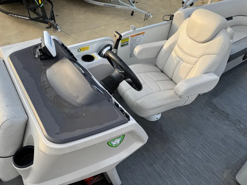 Slide: The Image of Captain's seat and console of 2022 Godfrey 2286 boat, featuring steering wheel and controls. - 5