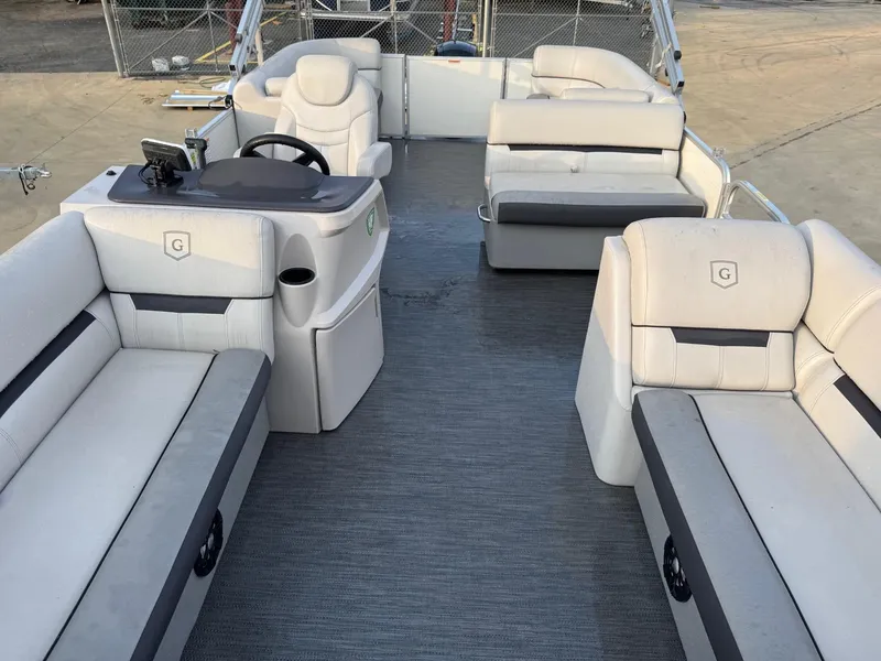Slide: The Image of 2022 Godfrey 2286 pontoon boat interior with plush seating and steering console. - 8