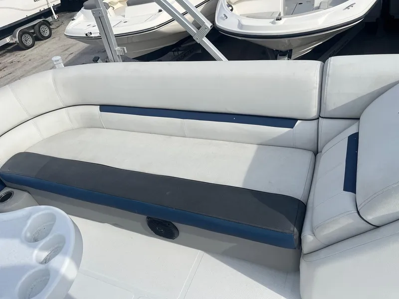 Slide: The Image of 2021 Hurricane FunDeck 236SB OB boat interior with white and blue seating. - 10