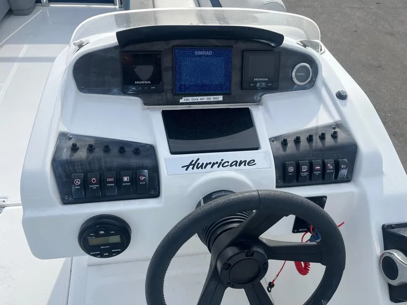 Slide: The Image of 2021 Hurricane FunDeck 236SB OB boat dashboard with steering wheel and control panel. - 6