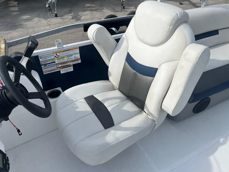 Slide: The Image of Captain's seat on 2021 Hurricane FunDeck 236SB OB boat, featuring sleek design and controls. - 7