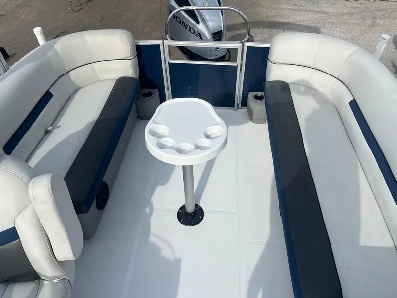Slide: The Image of 2021 Hurricane FunDeck 236SB OB interior with seating and table, featuring a Honda outboard motor. - 8