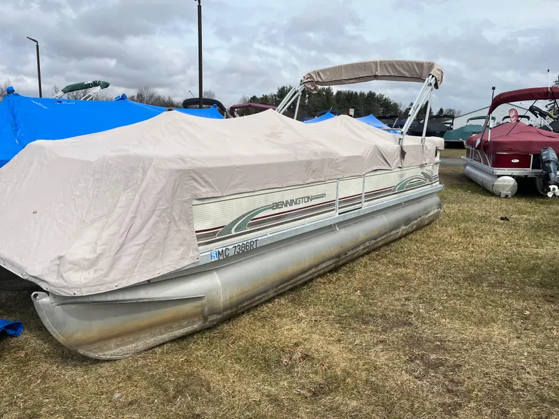 Slide: The Image of Covered 1998 Bennington LX 2280 pontoon boat on grassy area, overcast sky. - 1