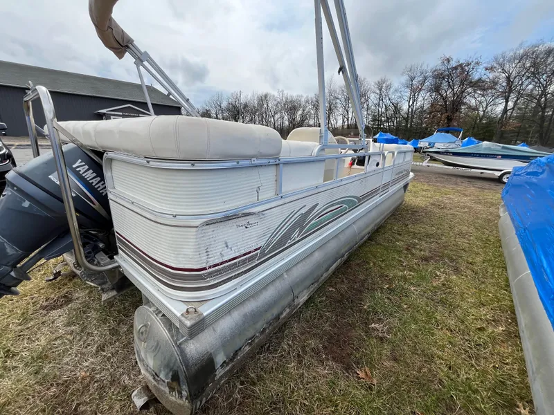 Slide: The Image of 1998 Bennington LX 2280 pontoon boat with Yamaha motor, parked on grass. - 11