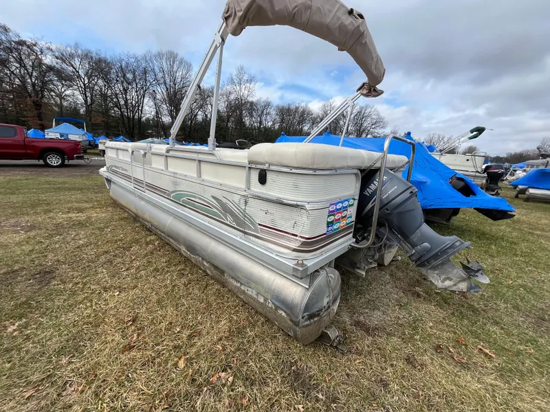 Slide: The Image of 1998 Bennington LX 2280 pontoon boat on grass, with Yamaha outboard motor. - 8