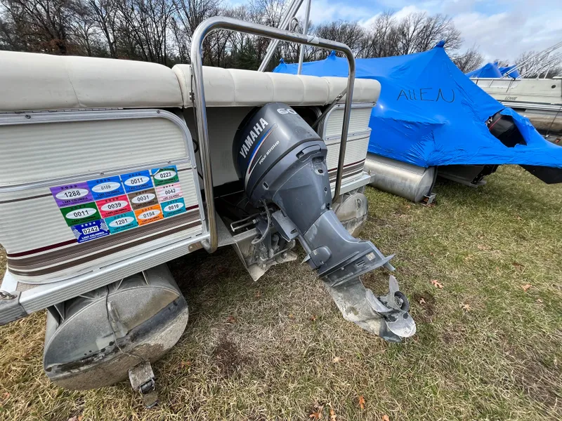 Slide: The Image of 1998 Bennington LX 2280 pontoon boat with Yamaha outboard motor, parked on grass. - 9