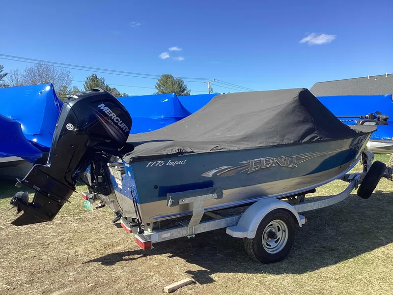 Slide: The Image of 2016 Lund 1775 Impact boat with Mercury engine, covered and on a trailer. - 3