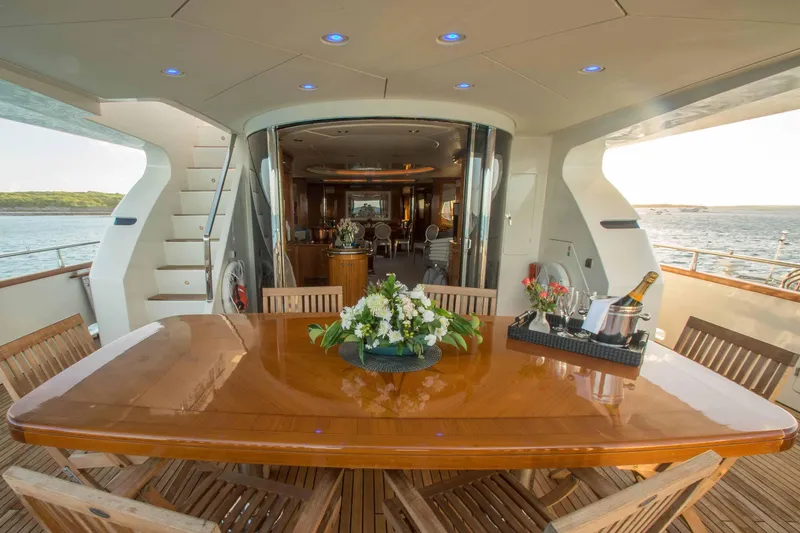 Slide: The Image of Luxurious 1999 Azimut 5 Stateroom VIP Edition yacht with elegant outdoor dining area. - 27