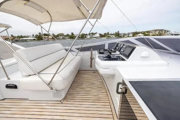 Slide: The Image of Luxurious 1999 Azimut yacht deck with seating and navigation controls, featuring elegant wood flooring. - 9