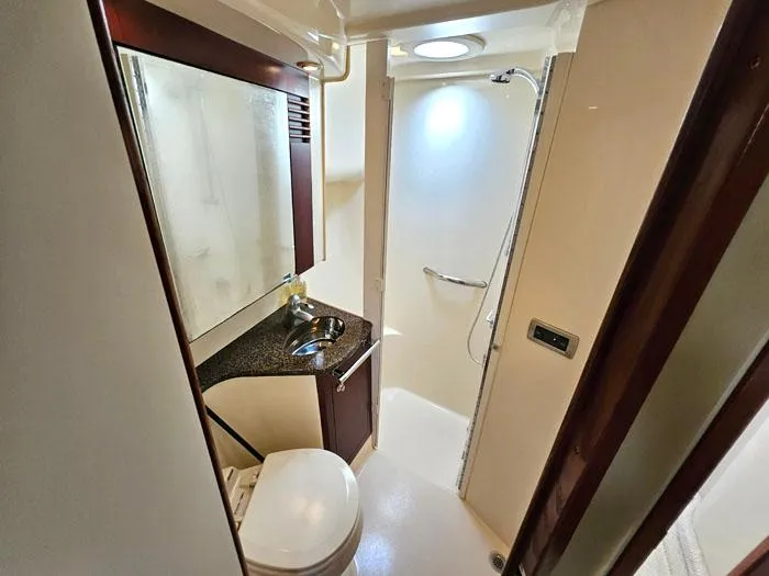 Slide: The Image of Bathroom interior of 2006 Sea Ray 44 Sedan Bridge yacht, featuring shower and vanity. - 13