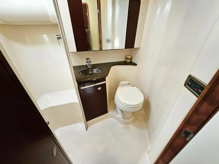 Slide: The Image of Bathroom interior of 2006 Sea Ray 44 Sedan Bridge yacht, featuring sink and toilet. - 15