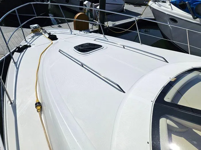 Slide: The Image of 2006 Sea Ray 44 Sedan Bridge yacht deck with railing and hatch. - 22