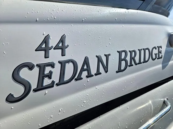 Slide: The Image of Close-up of 2006 Sea Ray 44 Sedan Bridge yacht nameplate with water droplets. - 25