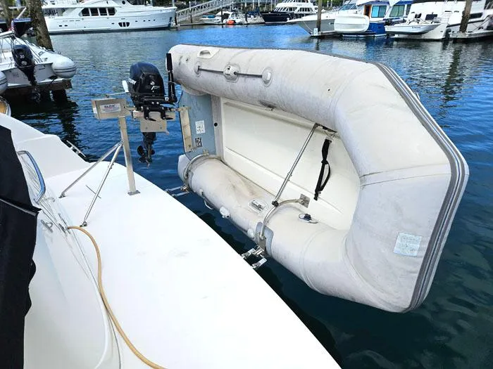 Slide: The Image of Inflatable dinghy attached to a 2006 Sea Ray 44 Sedan Bridge yacht in a marina. - 4