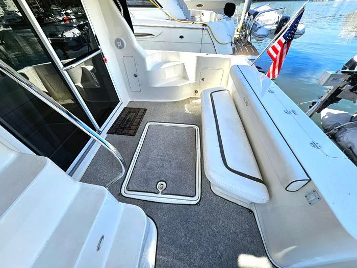 Slide: The Image of 2006 Sea Ray 44 Sedan Bridge yacht deck with seating and American flag. - 5