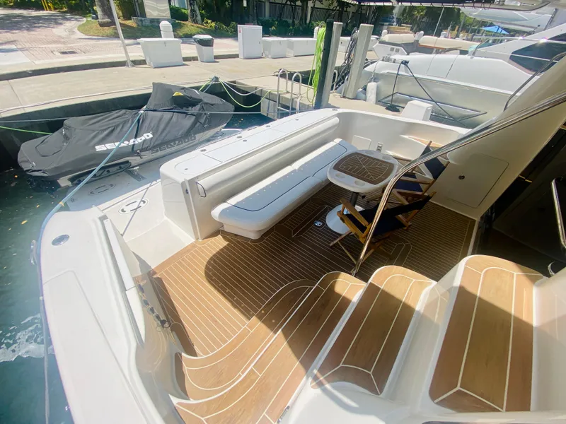 Slide: The Image of 2006 Sea Ray 580 Sedan Bridge yacht with spacious deck and seating area. - 13