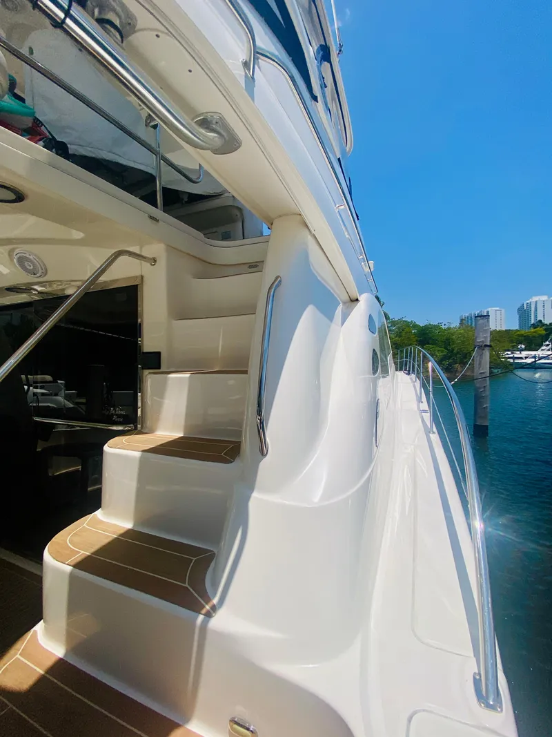 Slide: The Image of 2006 Sea Ray 580 Sedan Bridge yacht with exterior stairs and marina view. - 14
