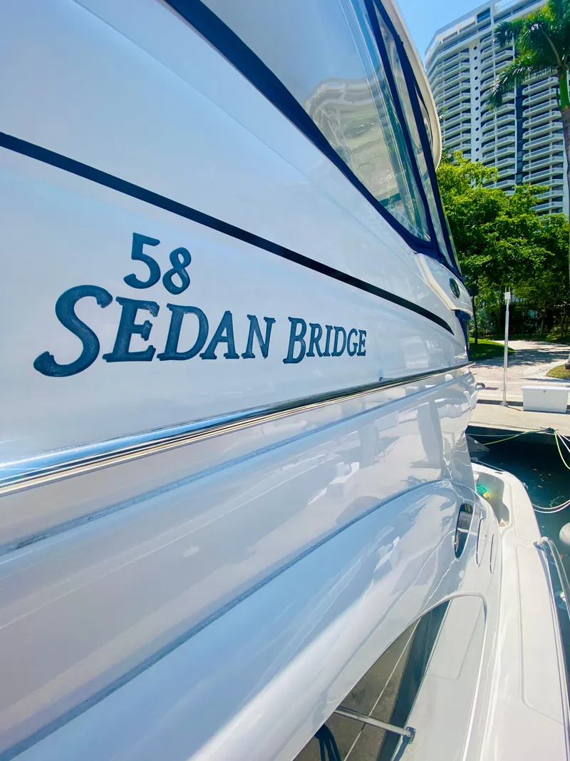 Slide: The Image of 2006 Sea Ray 580 Sedan Bridge yacht docked near modern buildings. - 16